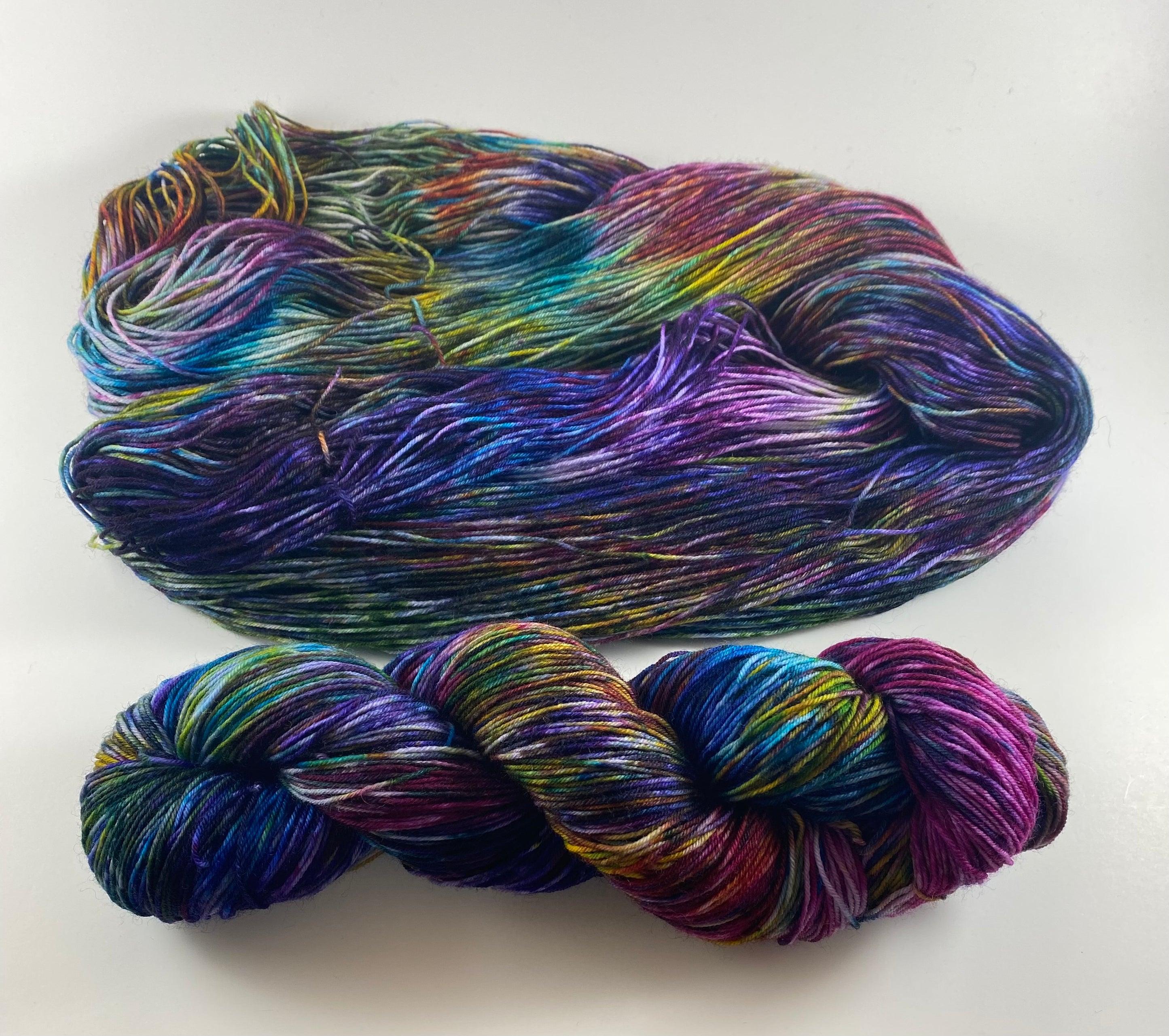 multicolored hand-dyed yarn in colors that look like stained glass - or a bag of dice
